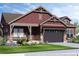 Charming two-story home featuring a symmetrical facade, stylish design elements, and professional landscaping at 14115 Blue Stem St, Broomfield, CO 80020