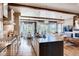 Open-concept kitchen featuring a large island, modern appliances, and seamless flow to the adjacent living area at 14115 Blue Stem St, Broomfield, CO 80020