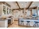 Bright kitchen with large island, stainless steel appliances, custom cabinets, and hardwood flooring at 14115 Blue Stem St, Broomfield, CO 80020