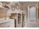 This laundry room features a sink, modern washer and dryer, shelving, and stylish decor at 14115 Blue Stem St, Broomfield, CO 80020