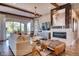Cozy living room featuring a fireplace, modern decor, and seamlessly flowing to the outdoors at 14115 Blue Stem St, Broomfield, CO 80020