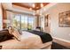 Inviting main bedroom features large windows, a designer ceiling fixture, and neutral decor at 14115 Blue Stem St, Broomfield, CO 80020