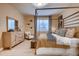A stylish main bedroom showcasing an elegant four-poster bed and tasteful furnishings at 14115 Blue Stem St, Broomfield, CO 80020