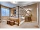 Bright main bedroom featuring a four-poster bed, stylish decor, and lots of natural light at 14115 Blue Stem St, Broomfield, CO 80020