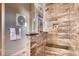 Walk-in shower with designer tile, a built-in bench, and modern fixtures at 14115 Blue Stem St, Broomfield, CO 80020