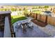A nicely landscaped backyard with a stone patio, fire pit, chairs, and manicured garden beds at 12841 Galapago St, Westminster, CO 80234