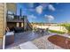 An expansive backyard patio features a stone fireplace, dining set, and beautiful landscaping at 12841 Galapago St, Westminster, CO 80234