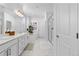 Luxurious bathroom with marble floors, a large vanity, soaking tub, and a separate glass-enclosed shower at 12841 Galapago St, Westminster, CO 80234