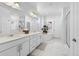 Bright bathroom featuring a double vanity, soaking tub, and glass enclosed shower for a spa-like experience at 12841 Galapago St, Westminster, CO 80234