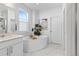 Bright white bathroom with a stand-alone soaking tub, stylish fixtures, and a modern, clean design at 12841 Galapago St, Westminster, CO 80234