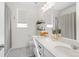 Modern bathroom featuring dual sinks, a large mirror, and minimalist decor for a clean, contemporary look at 12841 Galapago St, Westminster, CO 80234