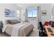 Comfortable bedroom with a bed, desk, and a large window offering a scenic view, perfect for relaxation at 12841 Galapago St, Westminster, CO 80234