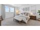 Bright, spacious bedroom with large windows and mountain views, furnished with neutral-toned decor and a bench at 12841 Galapago St, Westminster, CO 80234