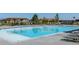 A serene community pool with lounge chairs and shaded pergolas, perfect for relaxation and recreation at 12841 Galapago St, Westminster, CO 80234