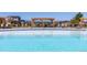 A refreshing community pool with comfortable lounge chairs under shaded pergola structures at 12841 Galapago St, Westminster, CO 80234