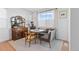 Cozy dining nook with banquette seating, farmhouse decor, and a large window with natural light at 12841 Galapago St, Westminster, CO 80234