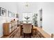 Open dining room with high ceilings, a wooden table with bench, and stylish accents at 12841 Galapago St, Westminster, CO 80234