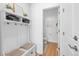 Bright entryway featuring a white hall tree with bench and shelves, leading to a half bath at 12841 Galapago St, Westminster, CO 80234