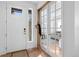 Bright entryway with a white door, hardwood floors, and French doors leading to another room at 12841 Galapago St, Westminster, CO 80234