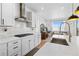 Elegant kitchen boasting white cabinets, quartz countertops, stainless steel appliances, and a stylish backsplash at 12841 Galapago St, Westminster, CO 80234