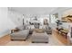 Open-concept living area with large sofa, lots of seating, hardwood floors, and natural light at 12841 Galapago St, Westminster, CO 80234