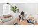 Bright home office with a modern desk, comfortable seating, and a large houseplant at 12841 Galapago St, Westminster, CO 80234