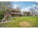 Expansive backyard with a playset and a two-story home featuring a spacious deck at 8424 E Otero Cir, Centennial, CO 80112