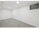 Finished basement features neutral carpeting and a single window at 8424 E Otero Cir, Centennial, CO 80112