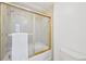 Tiled bathroom with glass enclosed tub/shower combo at 8424 E Otero Cir, Centennial, CO 80112