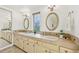 Bright double vanity bathroom with tile counters, gold framed mirrors, and decorative lighting at 8424 E Otero Cir, Centennial, CO 80112