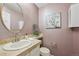 Cozy powder room with a round mirror, stone counter, and complementary wall art at 8424 E Otero Cir, Centennial, CO 80112
