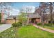 Charming brick home featuring a well-manicured lawn, brick walkway, and mature trees, perfect for curb appeal at 8424 E Otero Cir, Centennial, CO 80112