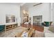 Spacious living room with hardwood floors, a fireplace, and seamless access to other areas of the home at 8424 E Otero Cir, Centennial, CO 80112