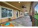 Covered patio with multiple ceiling fans, decorative wood flooring and a view of the backyard at 8424 E Otero Cir, Centennial, CO 80112