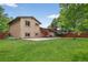 The exterior features a spacious yard, a concrete patio and a decorative pergola at 18445 W 59Th Dr, Golden, CO 80403