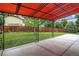 A spacious backyard featuring a covered patio and a well-maintained lawn at 18445 W 59Th Dr, Golden, CO 80403