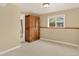 Basement area features carpet and large wooden cabinet near an adjacent bathroom at 18445 W 59Th Dr, Golden, CO 80403