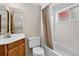 Bathroom features a shower-tub, vanity, toilet, tile walls and a bright window at 18445 W 59Th Dr, Golden, CO 80403