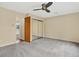 Spacious bedroom with neutral carpet, ceiling fan, and mirrored closet doors at 18445 W 59Th Dr, Golden, CO 80403