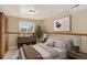 Inviting bedroom with a cozy atmosphere featuring carpet, a bright window, and a stylish decor; virtually staged at 18445 W 59Th Dr, Golden, CO 80403