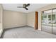 Bedroom featuring neutral carpet, mirrored closet, and ceiling fan at 18445 W 59Th Dr, Golden, CO 80403