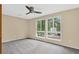 Bedroom with neutral walls, carpet, ceiling fan, and natural light from large windows at 18445 W 59Th Dr, Golden, CO 80403