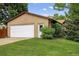 Exterior view of a single-story home with a two-car garage and neatly manicured lawn at 18445 W 59Th Dr, Golden, CO 80403