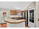 Bright kitchen featuring wood cabinets, tile countertops, and stainless steel appliances at 18445 W 59Th Dr, Golden, CO 80403