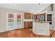 Kitchen featuring wood cabinets, stainless appliances, and access to the backyard at 18445 W 59Th Dr, Golden, CO 80403