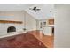 Spacious living room with vaulted ceilings, fireplace, and hardwood flooring flowing into the dining and kitchen area at 18445 W 59Th Dr, Golden, CO 80403