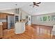 Open living room with vaulted ceilings, hardwood floors, and a kitchen bar at 18445 W 59Th Dr, Golden, CO 80403