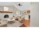 Cozy living room featuring a stone fireplace, hardwood floors, and elegant furnishings; virtually staged at 18445 W 59Th Dr, Golden, CO 80403
