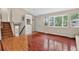 Light-filled foyer with hardwood floors, stairs to the basement, and a view into the cozy living room at 18445 W 59Th Dr, Golden, CO 80403