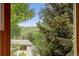 Picturesque view of lush trees and distant mountain, seen from inside the home at 18445 W 59Th Dr, Golden, CO 80403